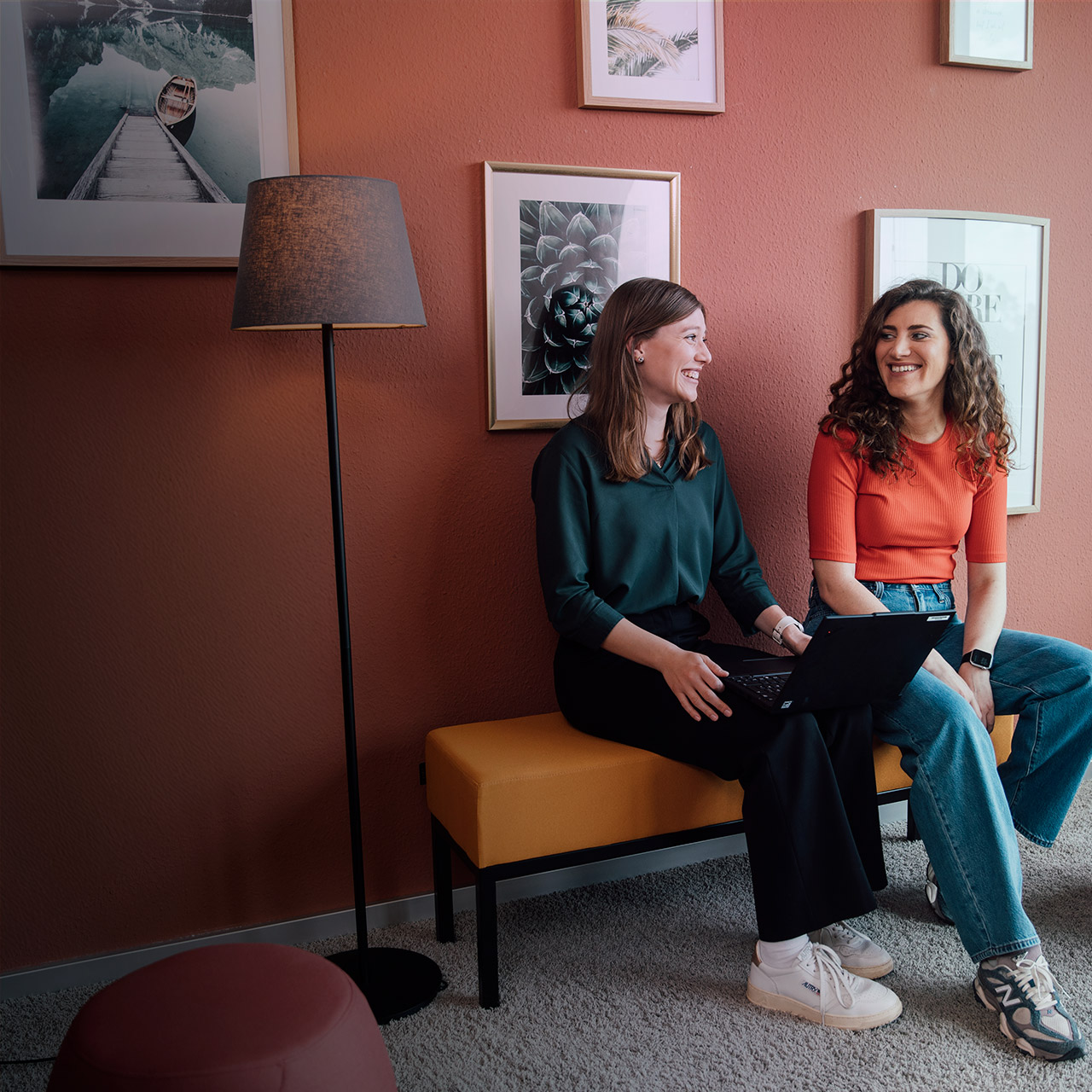 Two colleagues talking in an office setting.