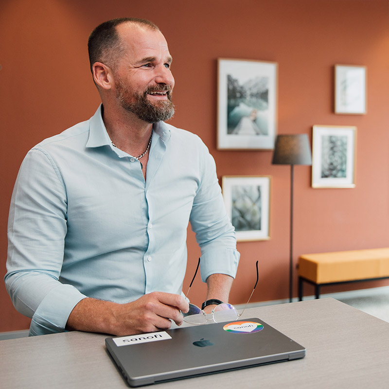Sanofian working at a table in the office