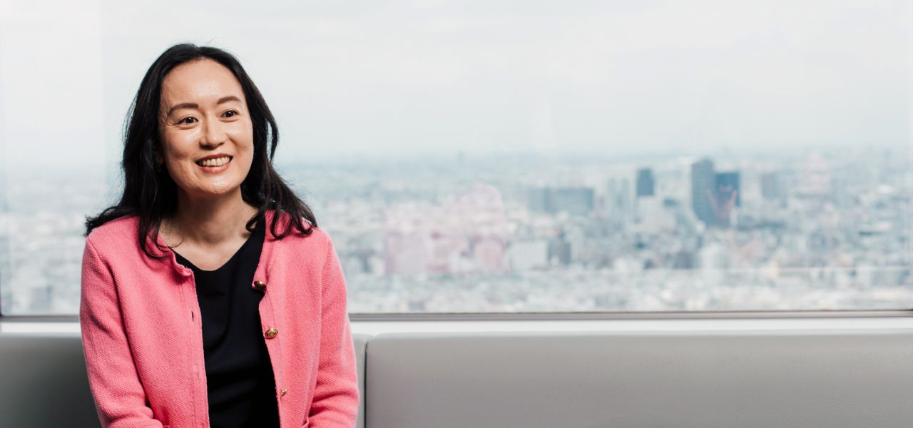 Sanofian working at office sat in front of window showing city landscape