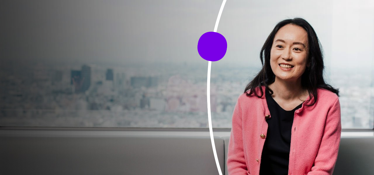 Sanofian working at office sat in front of window showing city landscape