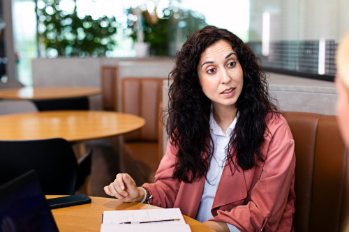 Person in conversation at table