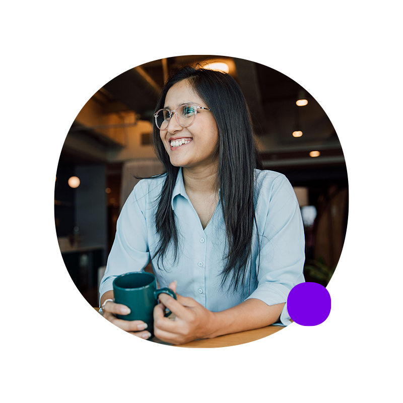 Man in profile, smiling in front of a wall of posted notes