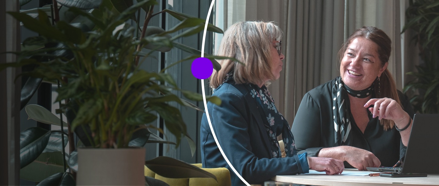 Person in conference room, laughing with other meeting attendees