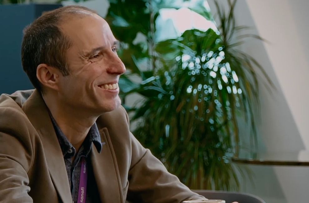 Two people listening to another coworker discussing a topic