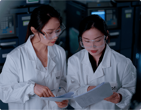 Lab employee in sterile garb, working with tweezers