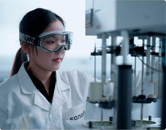 Lab employee wearing safety glasses, sorting test samples