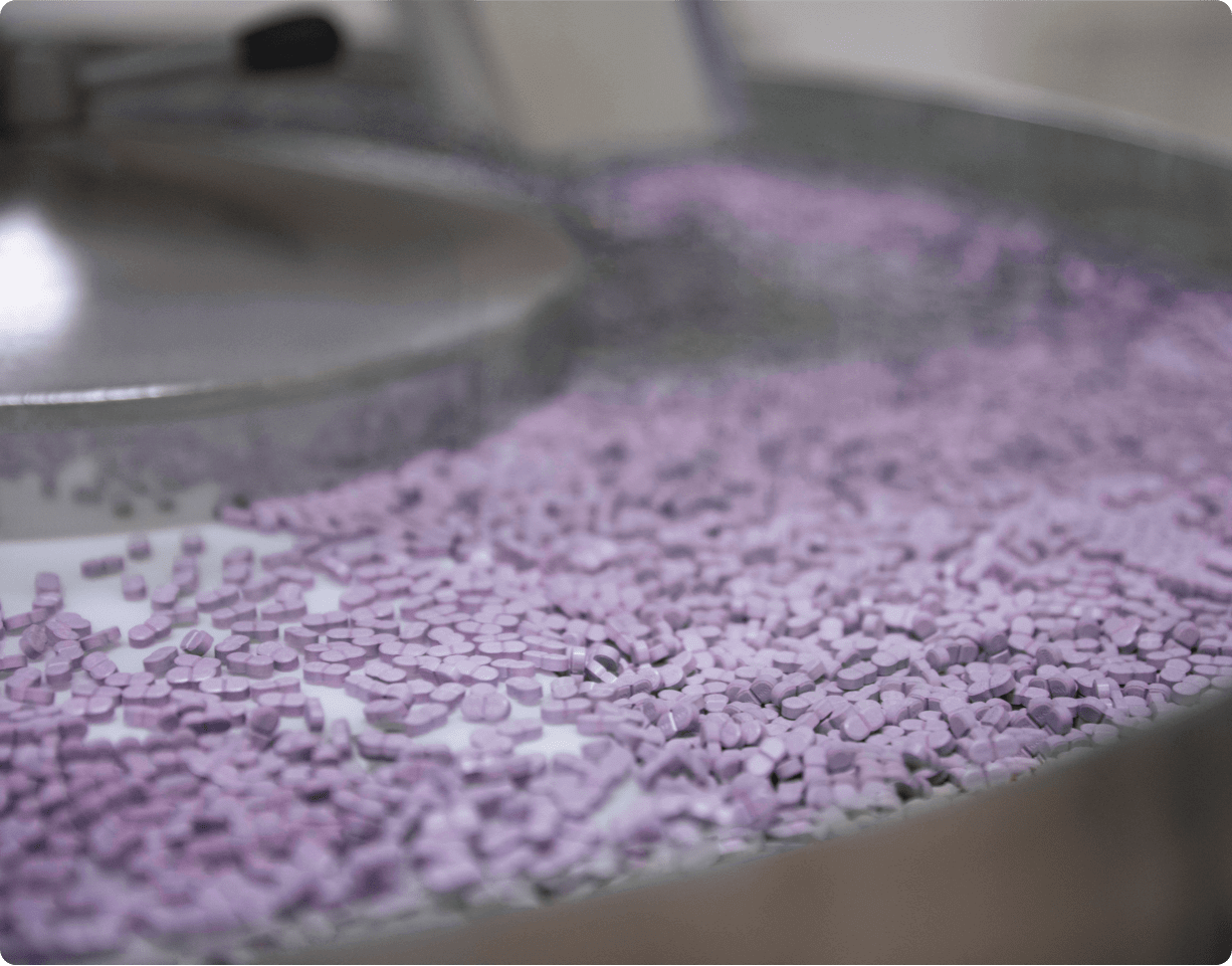 Pharmaceutical pills on a production conveyor belt