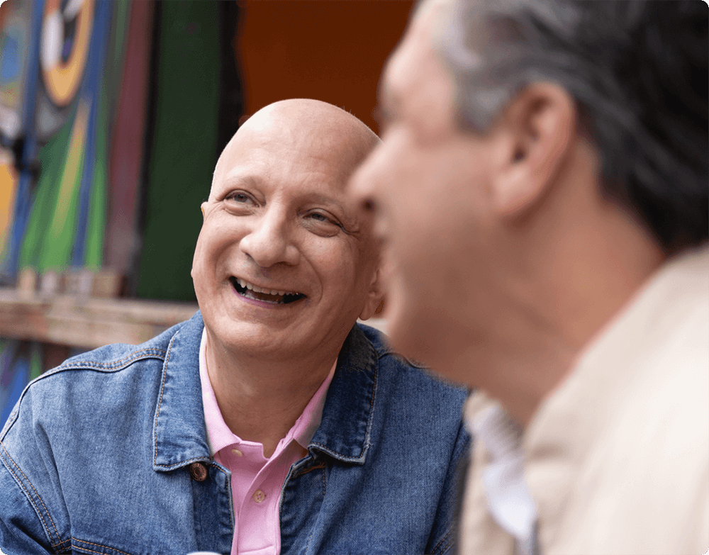 Two men laughing and talking
