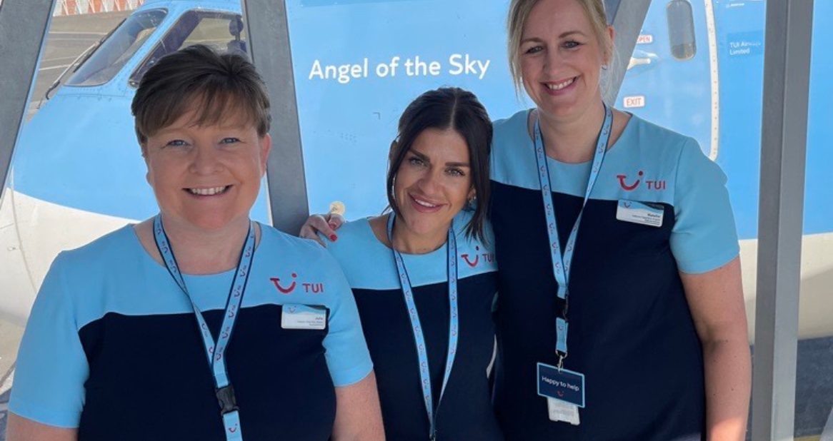 Three female TUI Airport Representatives stand in front of our "Angel of the Sky" aircraft.