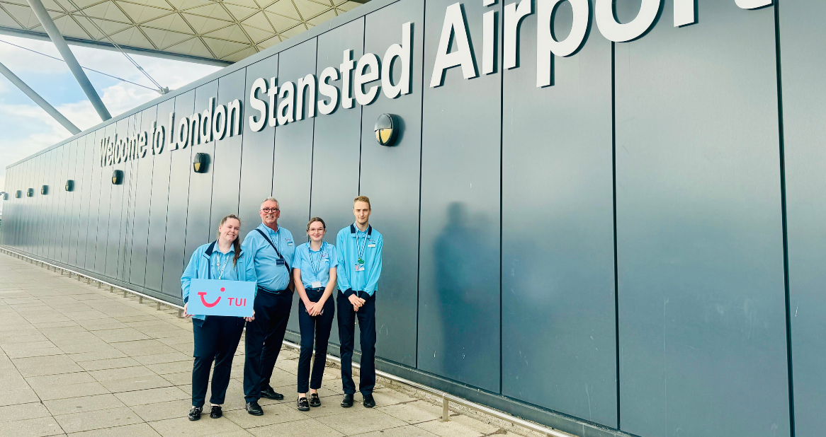 Four TUI Airport Reps stand in front of London Stagnated Airport.