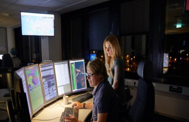 two colleagues in front of their computer screens