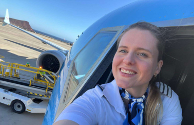 A female pilot taking a selfie from inside the cockpit