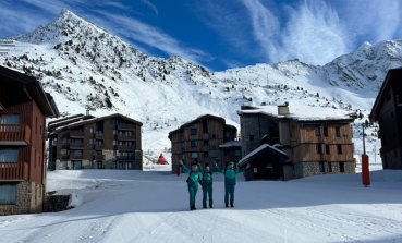 Three Crystal Ski colleagues stand in a ski resort town