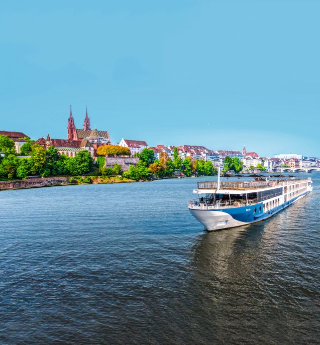A river cruise ship with a blue sky and city background
