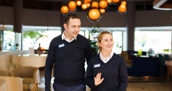 Two colleagues walking in a reception