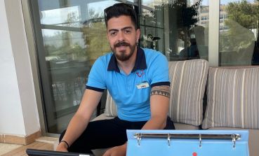 A TUI Rep sits in a hotel smiling