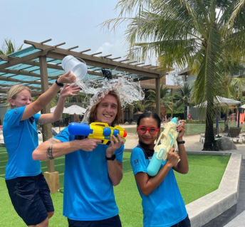 three entertainers playing with water guns