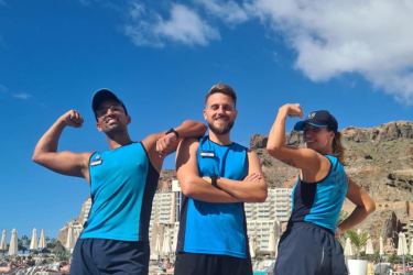 Two male and one female sports coaches showing their muscles