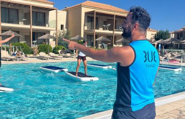 A TUI BLUE colleague conducts an Aquaboard class at the hotel pool