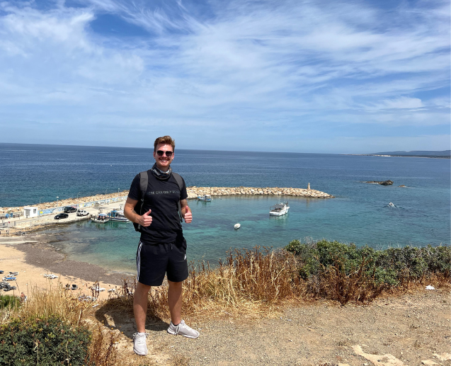 A TUI Cyprus colleague smiles in front of the sea in Paphos