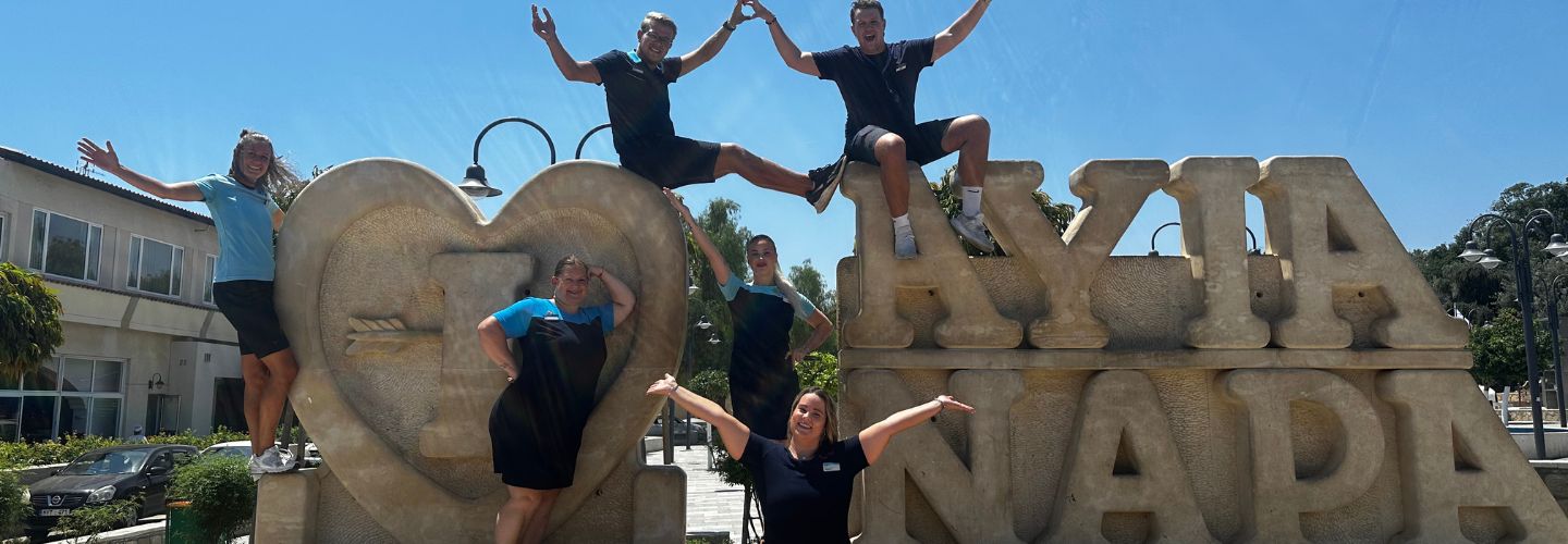 A group of TUI Cyprus destination colleagues stand alongside a large Ayia Napa sign.