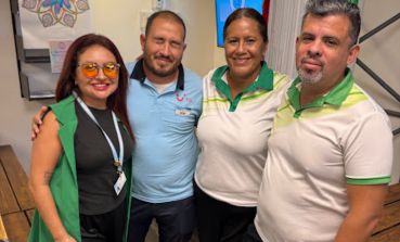 Four colleagues stand smiling together in our Mexico office