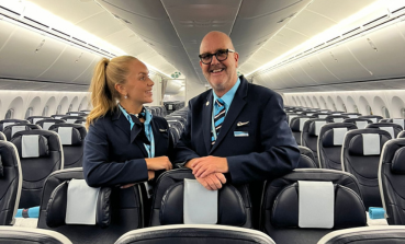 A male and female TUI fly Nordic Cabin Crew member smiles together on board our 787 Dreamliner aircraft.