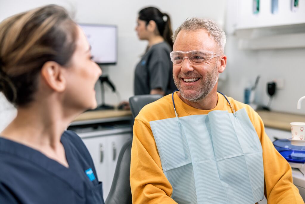 Patient smiling with dentist in clinic