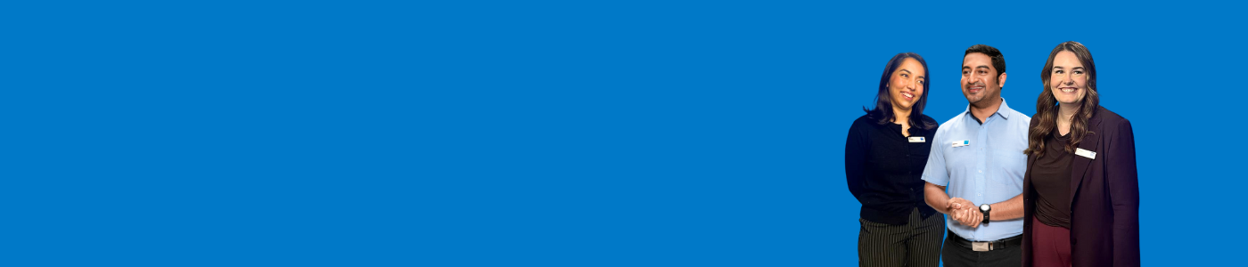 Three staff members standing together on blue background