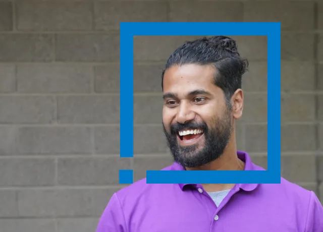 Smiling person in purple shirt