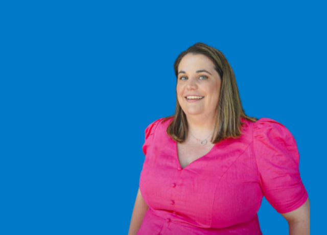 Person in pink blouse on blue background