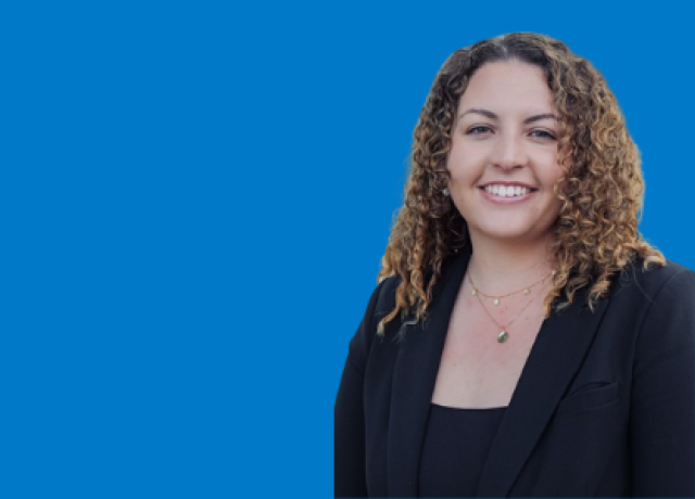 Person in business attire against blue background