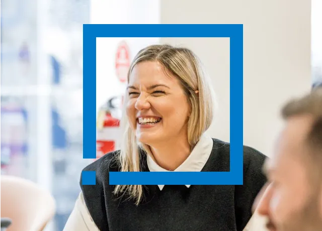 Woman smiling in meeting with face frame