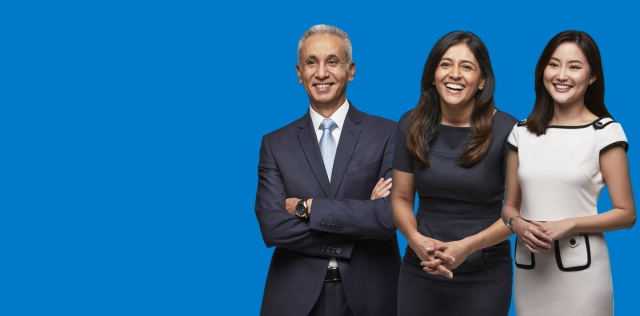 Three people smiling on blue background