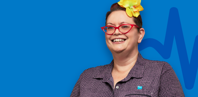 Smiling woman with red glasses on blue background