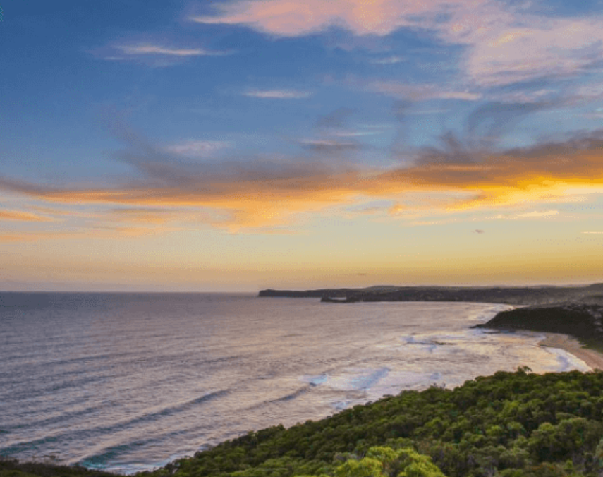 Coastal view at sunset with ocean and cliffs