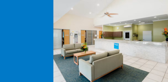 Modern clinic lobby with reception and sofas