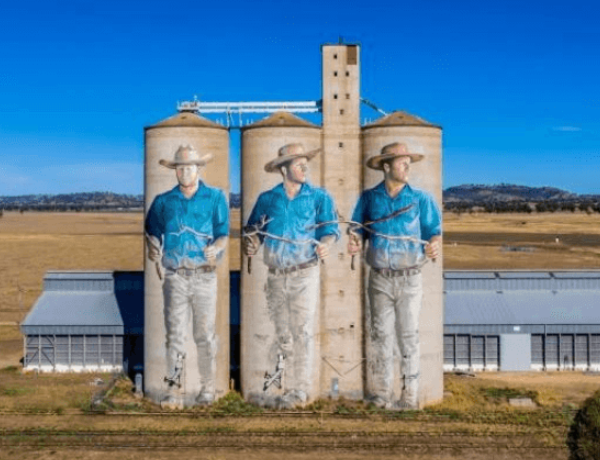 Silos painted with three cowboys mural