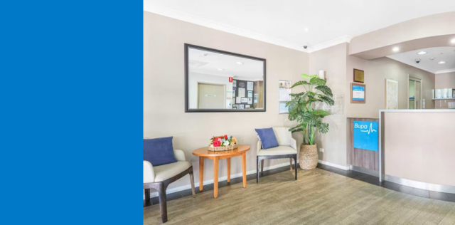 Clinic waiting area with chairs and reception desk