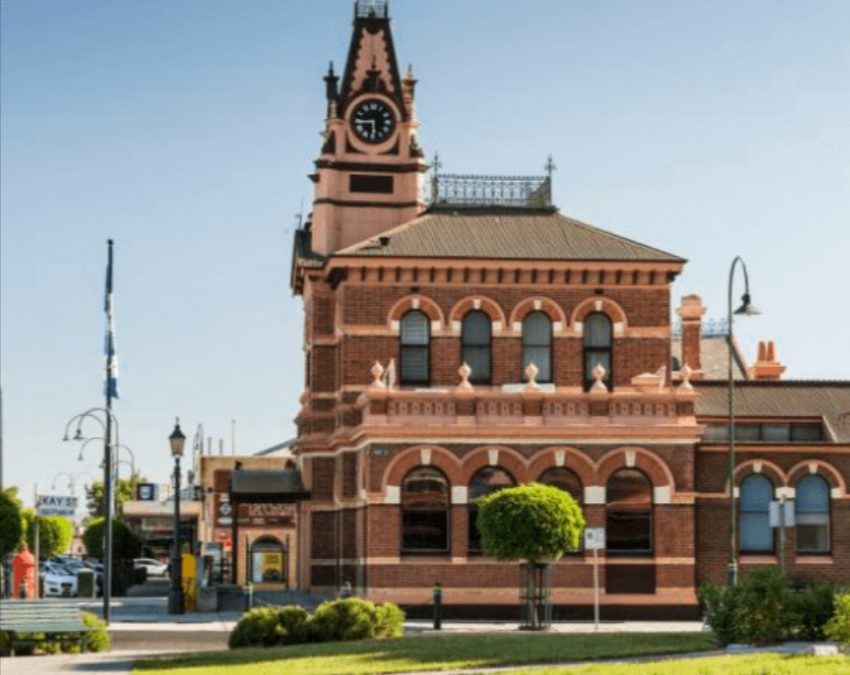 Historic brick clock tower building in town square