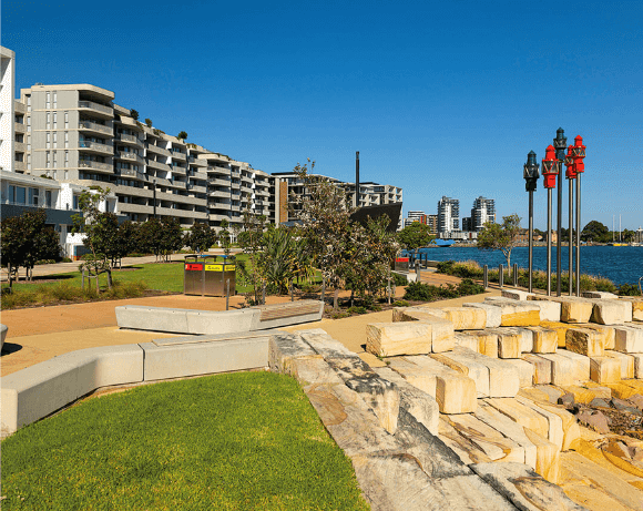 Waterfront park with apartments and sculptures