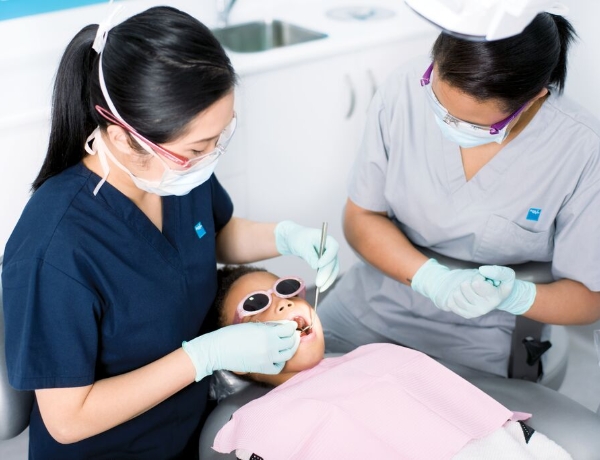 Dental professionals providing treatment to a child patient