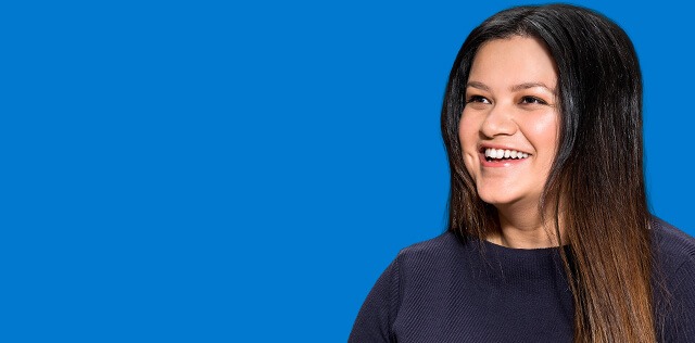 Woman smiling in a blue background