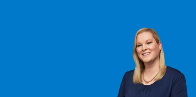 Person smiling on blue background
