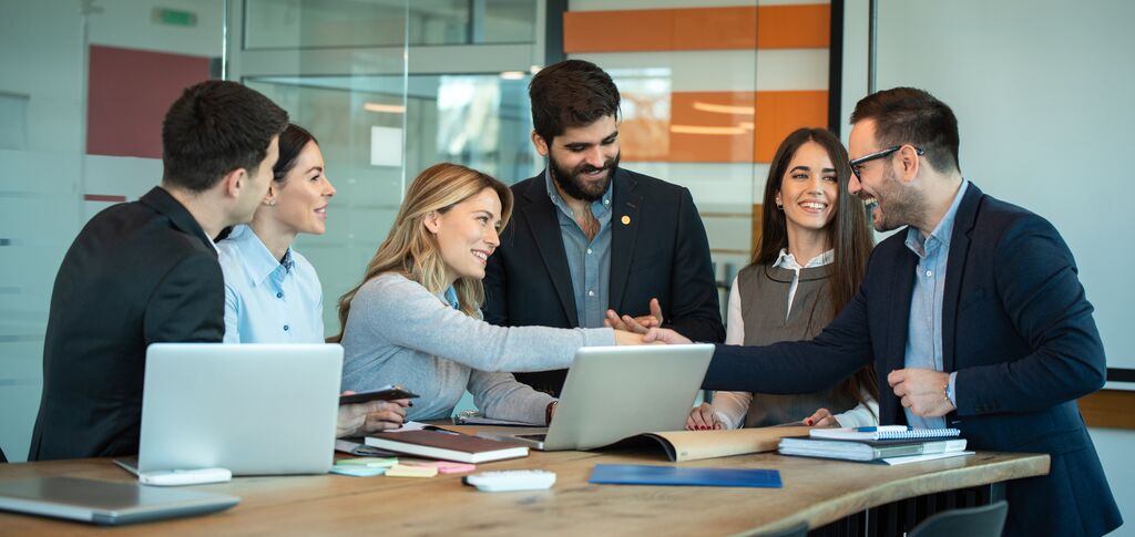 People shaking hands in office meeting