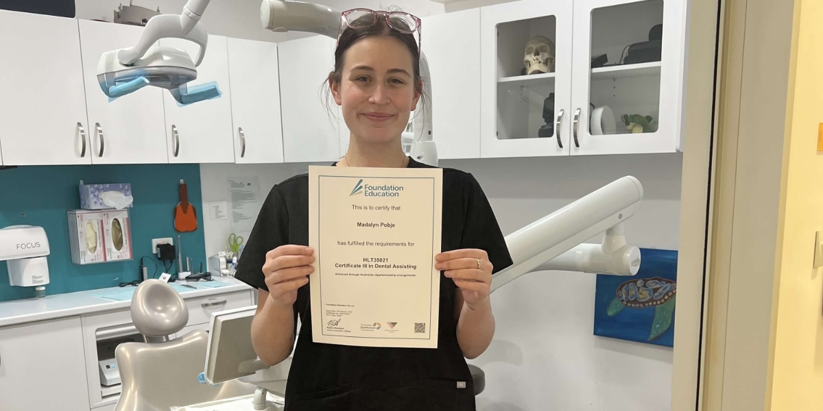 Person holding certificate in dental clinic