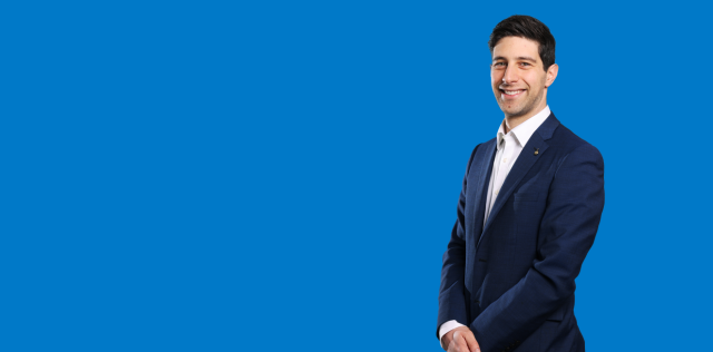 Person in blue suit against blue background