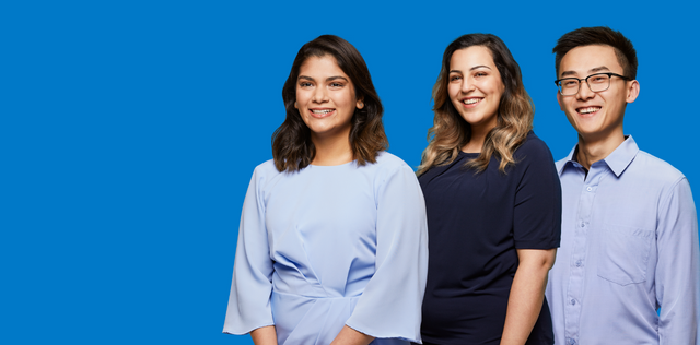 Three people posing against blue background