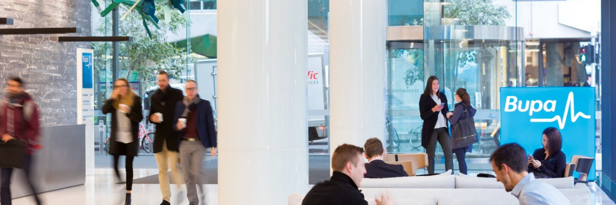 People in Bupa lobby with seating and entrance