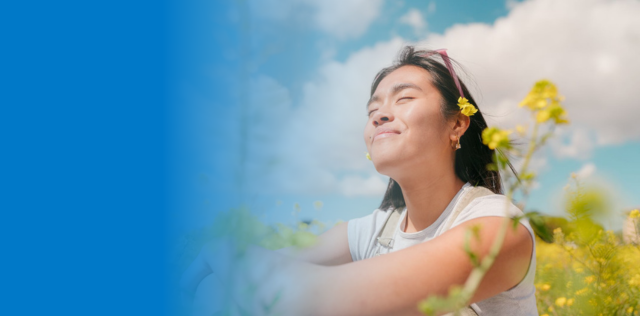 Person enjoying sunny field, blue banner